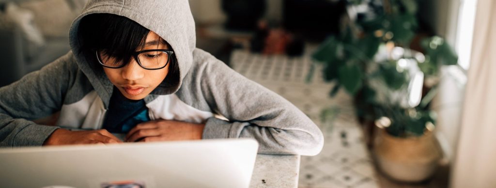 Young student working from home on laptop