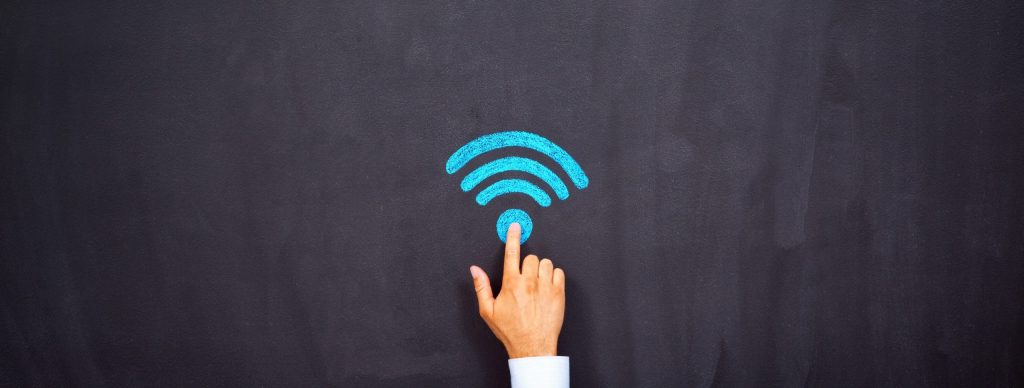 Man pointing at wifi symbol on chalkboard