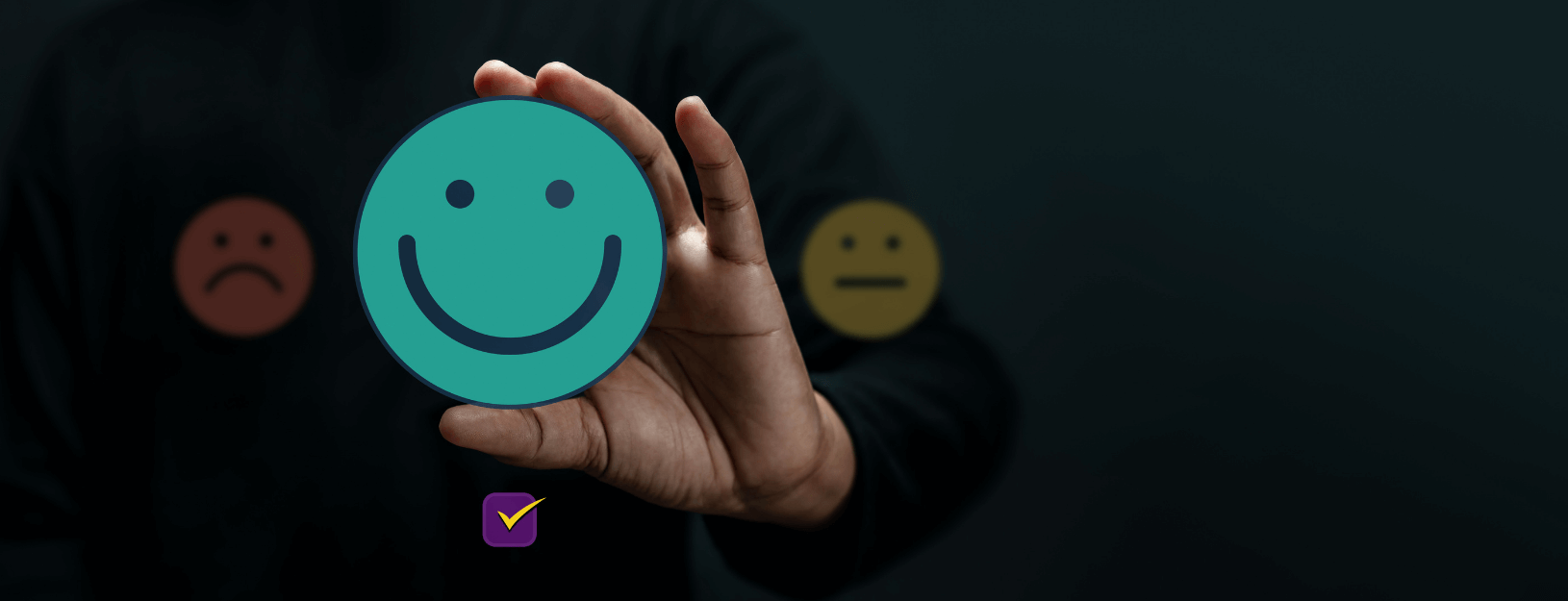 A person holding up a green happy face