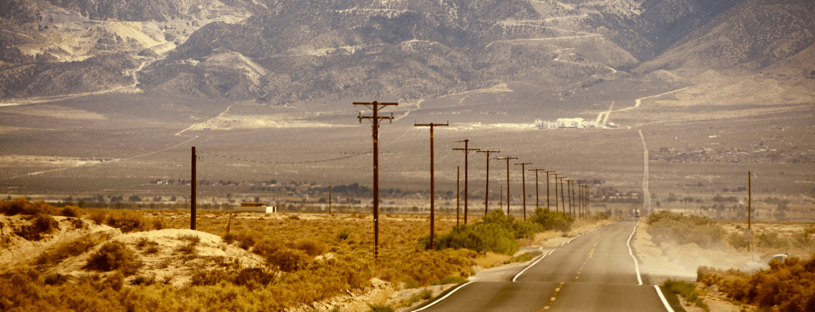 Picture of rural road with telephone poles stretching into the distance