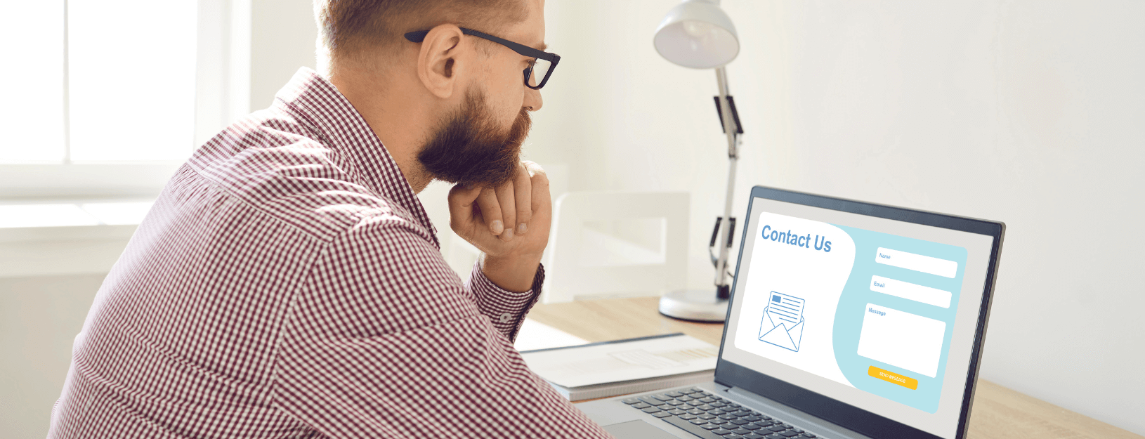 Man filling out contact us form online.