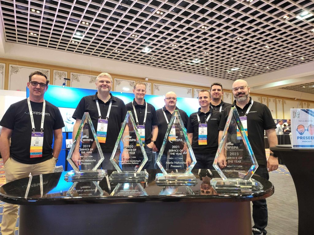 Members of the Preseem team pose with the 2023 WISPA Service of the Year Award at WISPAPALOOZA in Las Vegas.