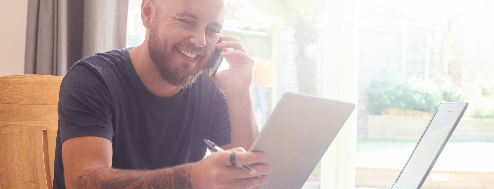 Man smiling while talking on the phone