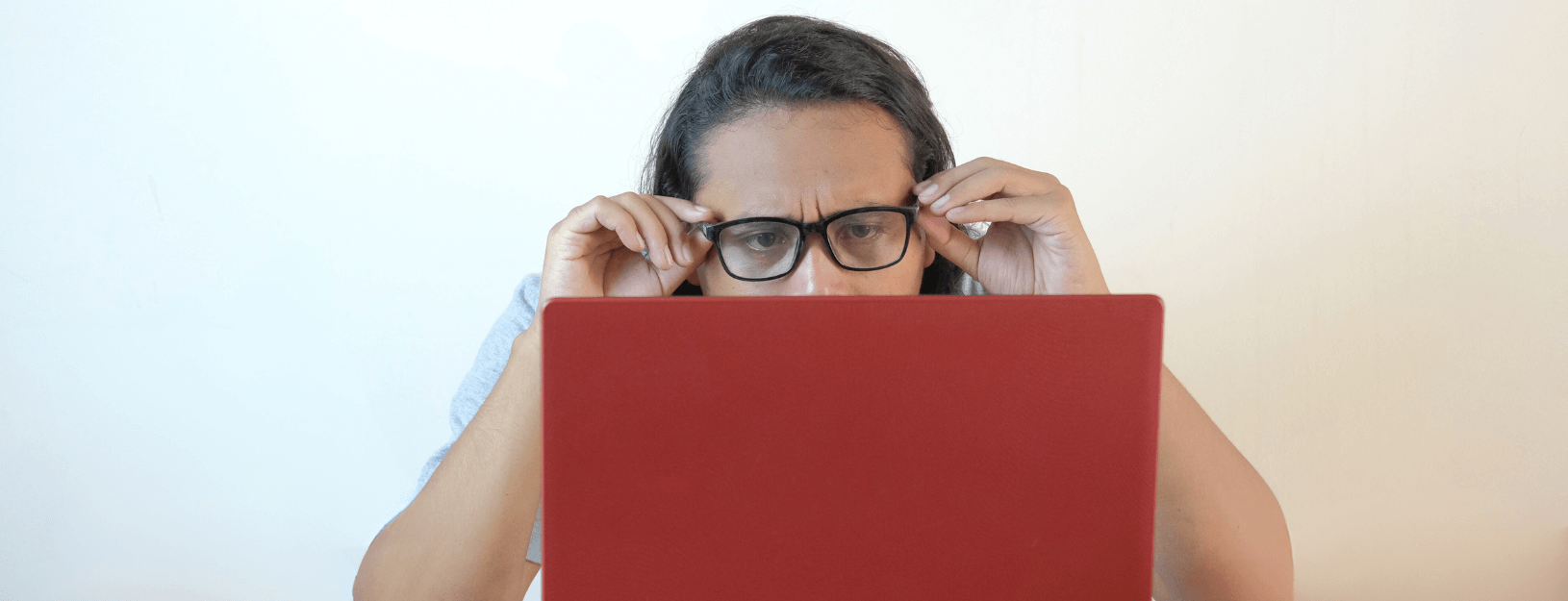 Man looks confused by something on his laptop.