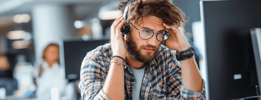 A support tech appears frustrated while on a call.
