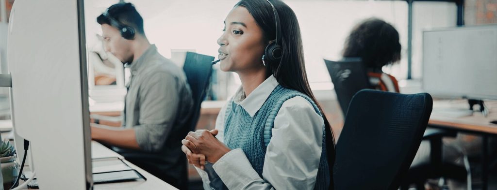 Image of a support team member talking to a customer on her headset